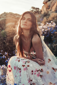 Inspired by desert blossoms in spring, Cora’s fully embroidered, vibrant florals are set on sand-dyed tulle to amplify the beautiful contrast of blooms throughout a bare terrain. A fully boned bodice wraps the body for ultimate support, balanced by a dramatic train with cascading embroidered florals. A playful take on a classic silhouette, Cora’s bright palette is perfect for the bride wanting to infuse colour into their celebrations.