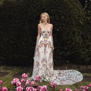 Inspired by desert blossoms in spring, Cora’s fully embroidered, vibrant florals are set on sand-dyed tulle to amplify the beautiful contrast of blooms throughout a bare terrain. A fully boned bodice wraps the body for ultimate support, balanced by a dramatic train with cascading embroidered florals. A playful take on a classic silhouette, Cora’s bright palette is perfect for the bride wanting to infuse colour into their celebrations.