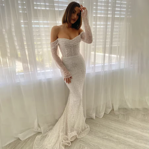 The Kaya Gown is the perfect choice for a glamorous bride. Its three-quarter length sleeves and stunning corset design with off-the-shoulder detail add a touch of elegance. The back zipper and button closure make it easy to wear, and its formal evening style is guaranteed to make you feel fashionable on your special day.