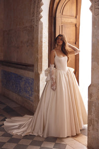 This stunning satin ballgown features a square neckline adorned with elegant pearls, a flattering basque waist, and a signature bow for added charm. Perfect for formal occasions, this gown will make you feel like royalty with its timeless design and luxurious details. Treat yourself to a touch of elegance with the Blanche Gown.