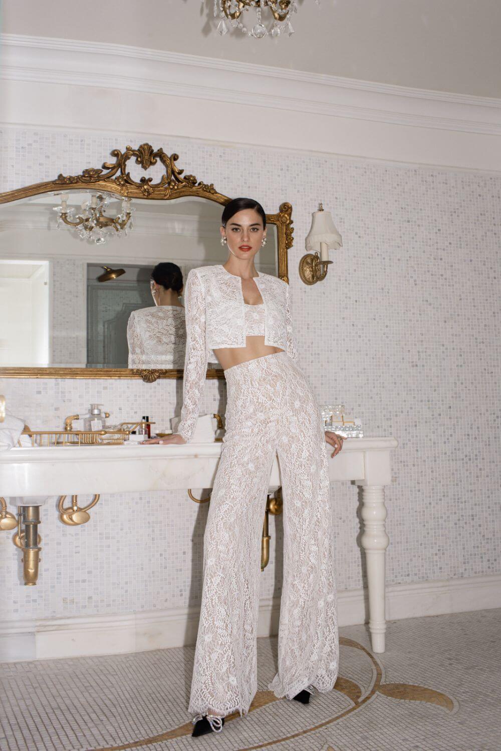 Step back in time with the Vivienne Set! This retro-inspired pant suit includes a lace crop top and little jacket, perfect for the bold and modern bride. Get the best of both worlds with a nod to the sixties and a chic, wild child twist. Say "I do" in style and turn heads with this stunning ensemble.