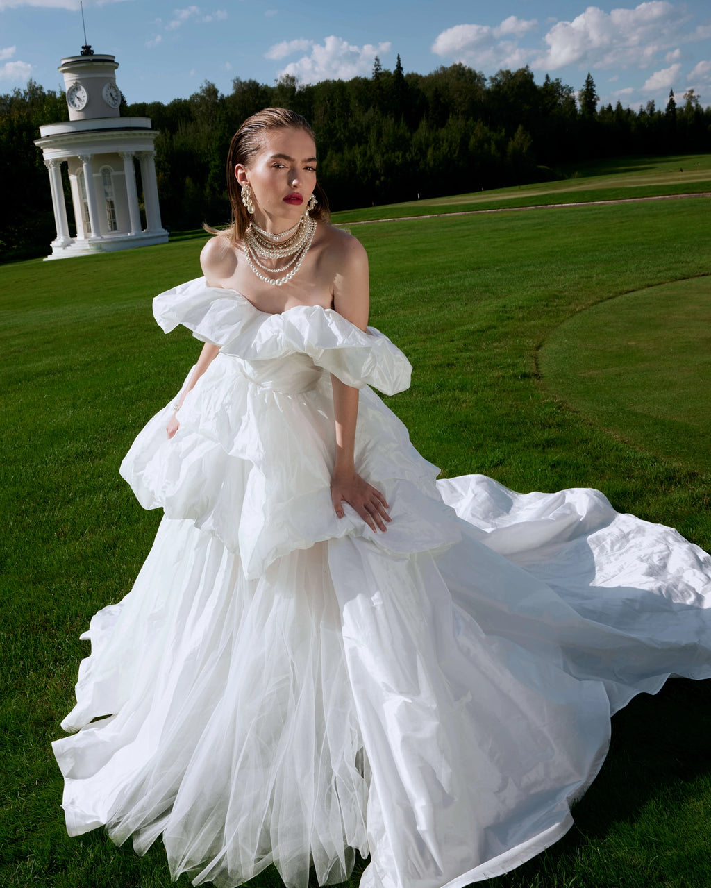 Elevate your special day with the Fenny Gown. This ball-gown silhouette wedding dress features voluminous dropped straps and a hook-back closure. Crafted with luxurious taffeta, it exudes elegance and sophistication. Say "I do" in style with the Fenny Gown.