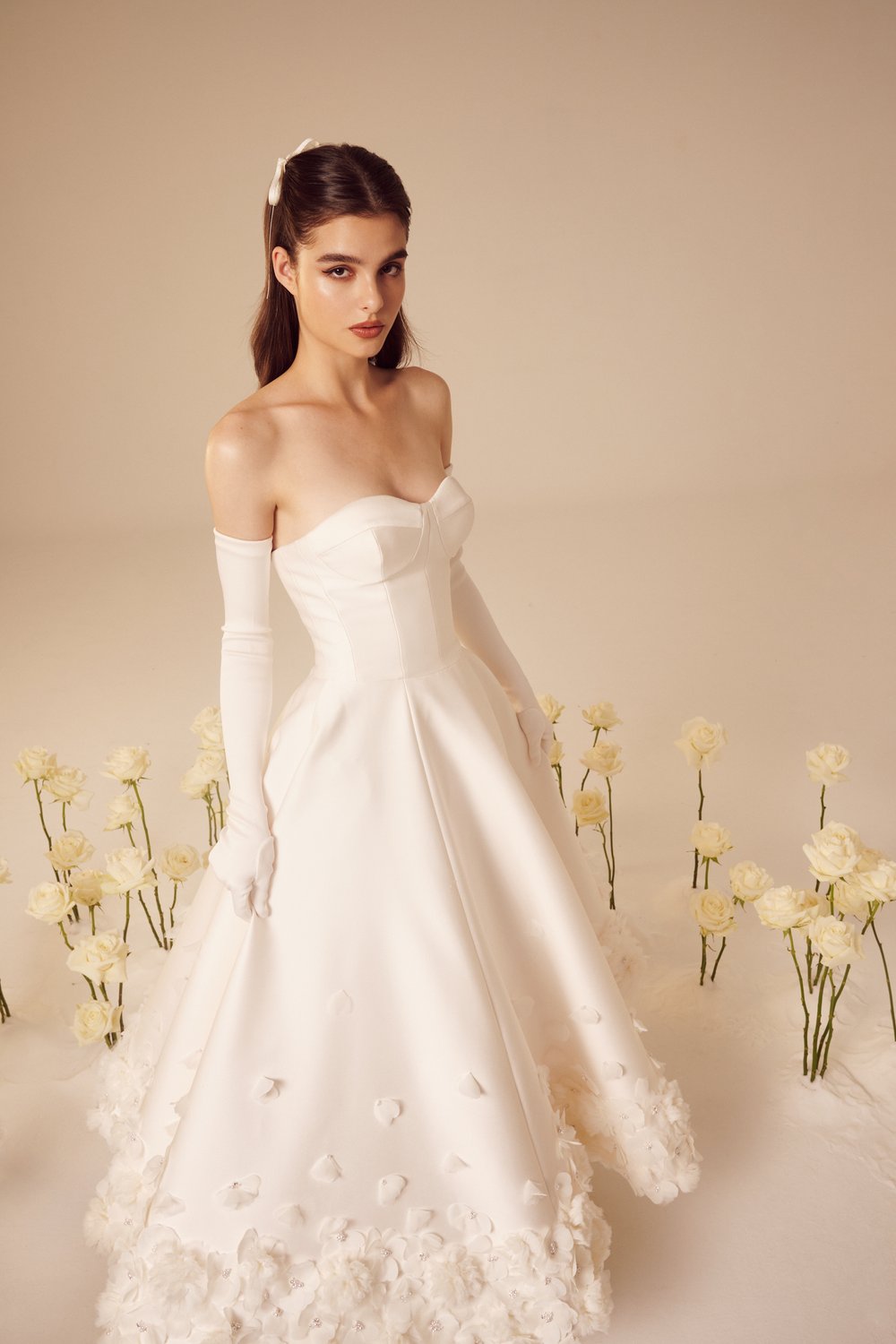 The Rosette Dress is the perfect blend of bold and romantic. Channel your inner Carrie Bradshaw and make a statement at any wedding event. Designed by the same designer as Taylor Swift's iconic Enchanted tour dress, this dress features beautiful rosette details throughout. Embrace this timeless trend with this midi silk wedding dress.