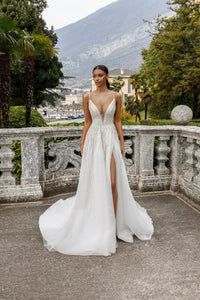 This stunning Claire Gown features an exquisite A-line design that will make any bride sparkle on her special day. With its elegant and chic style, this bridal dress is sure to make a statement. Perfect for a sophisticated bride looking for a timeless and classic look.