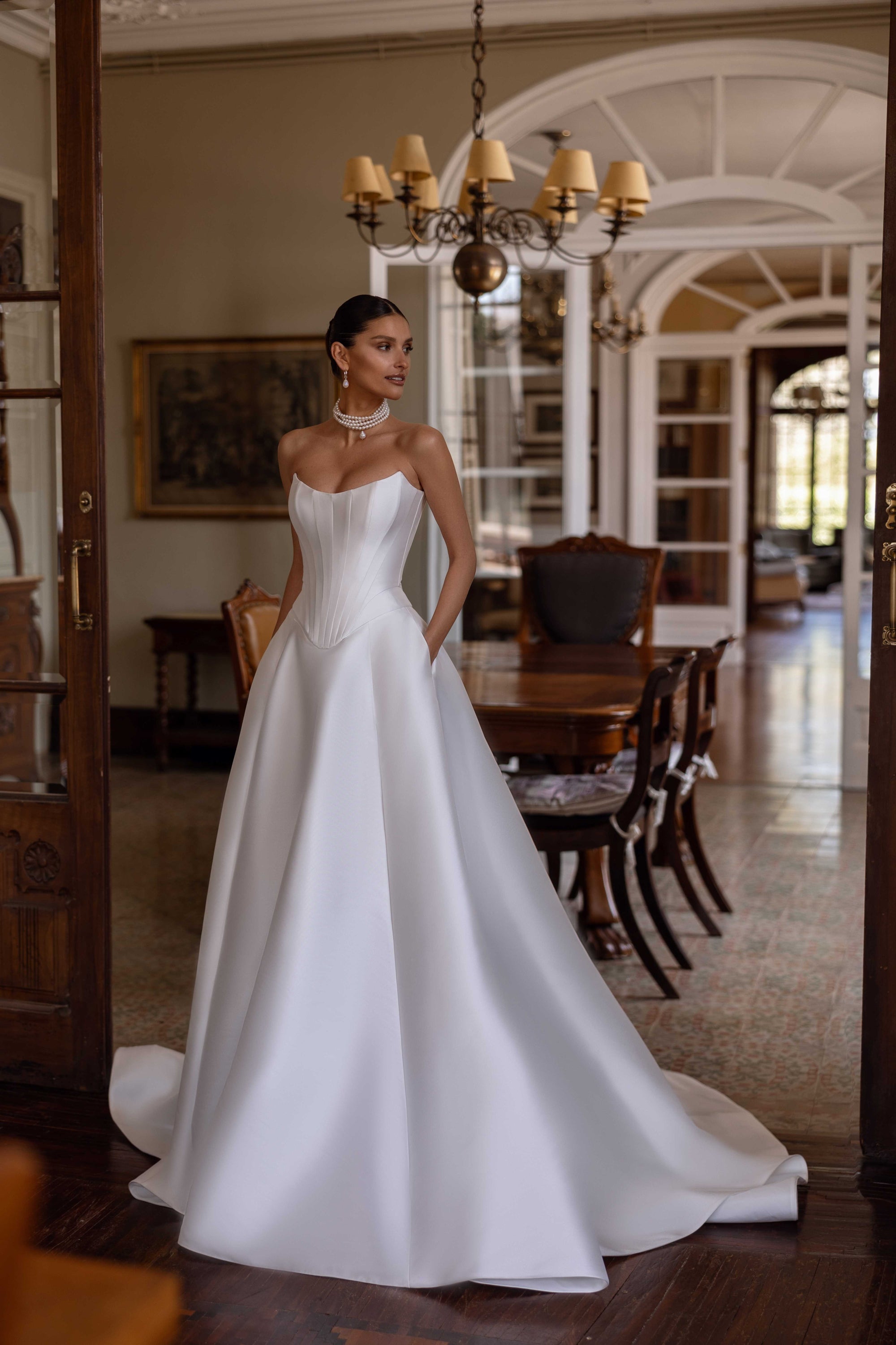 Indulge in luxury with the Florentina Gown. This exquisite satin corset bridal gown boasts an elegant and chic design, perfect for an enchanted wedding. Elevate your special day with this timeless and luxurious wedding dress.