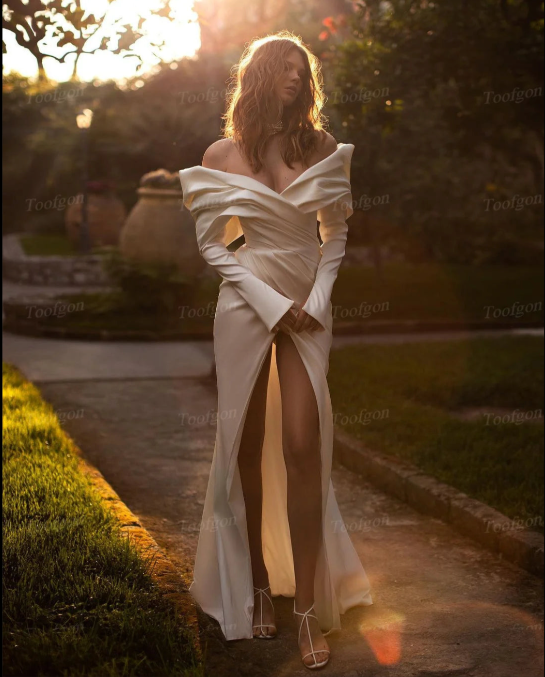 Indulge in the luxurious allure of our Robe Jeanine. Crafted with sumptuous mermaid satin, this wedding dress boasts elegant long sleeves and a pleated off-the-shoulder neckline. With its mermaid silhouette, this gown will beautifully highlight your figure. Perfect for the sophisticated bride who wants to make an unforgettable statement on her special day.