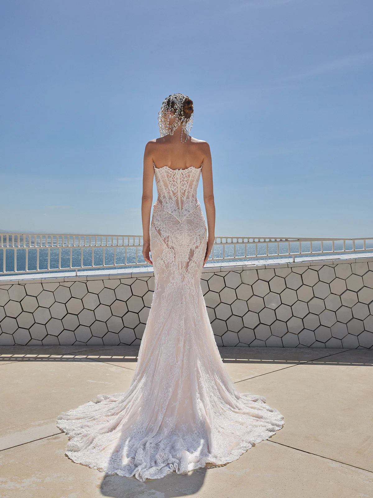 Indulge in pure luxury with the Eva Gown by Galia Lahav. This two-piece ensemble boasts a baroque-style strapless corset and an elongated mermaid skirt, both crafted from opulent embroidered French lace. The result is a striking and timeless silhouette that radiates elegance and grandeur. Elevate your style and make a statement with the Eva Gown.