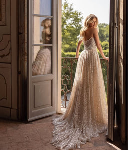 The Beatrice Sparkling Dress offers a strapless neckline and a two-in-one design, perfect for a unique and glamorous look. With its detachable train, it's perfect for luxurious galas. Designed with intricate detail and elegance, this dress will make any bride feel like royalty.