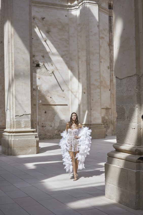 Make a bold entrance with the Katy Corset Dress. This mini-length gown features stunning all-over glitter and sequin details. Add the dramatic oversized cape, sold separately, for a touch of glamour with its feathers and glitter-stone embellishments. Stand out from the crowd in this semi-sheer showstopper.