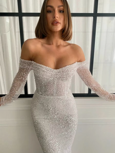 The Kaya Gown is the perfect choice for a glamorous bride. Its three-quarter length sleeves and stunning corset design with off-the-shoulder detail add a touch of elegance. The back zipper and button closure make it easy to wear, and its formal evening style is guaranteed to make you feel fashionable on your special day.