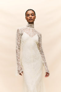 Look stunning on your special day with the Hermosa Dress, crafted from delicate vintage inspired lace that truly embodies our bohemian heritage. Featuring a flattering high neckline, long sleeves, and opulent button detailing, this style exudes effortless elegance. The romantic and sheer qualities of the lace add a touch of romance to your look.