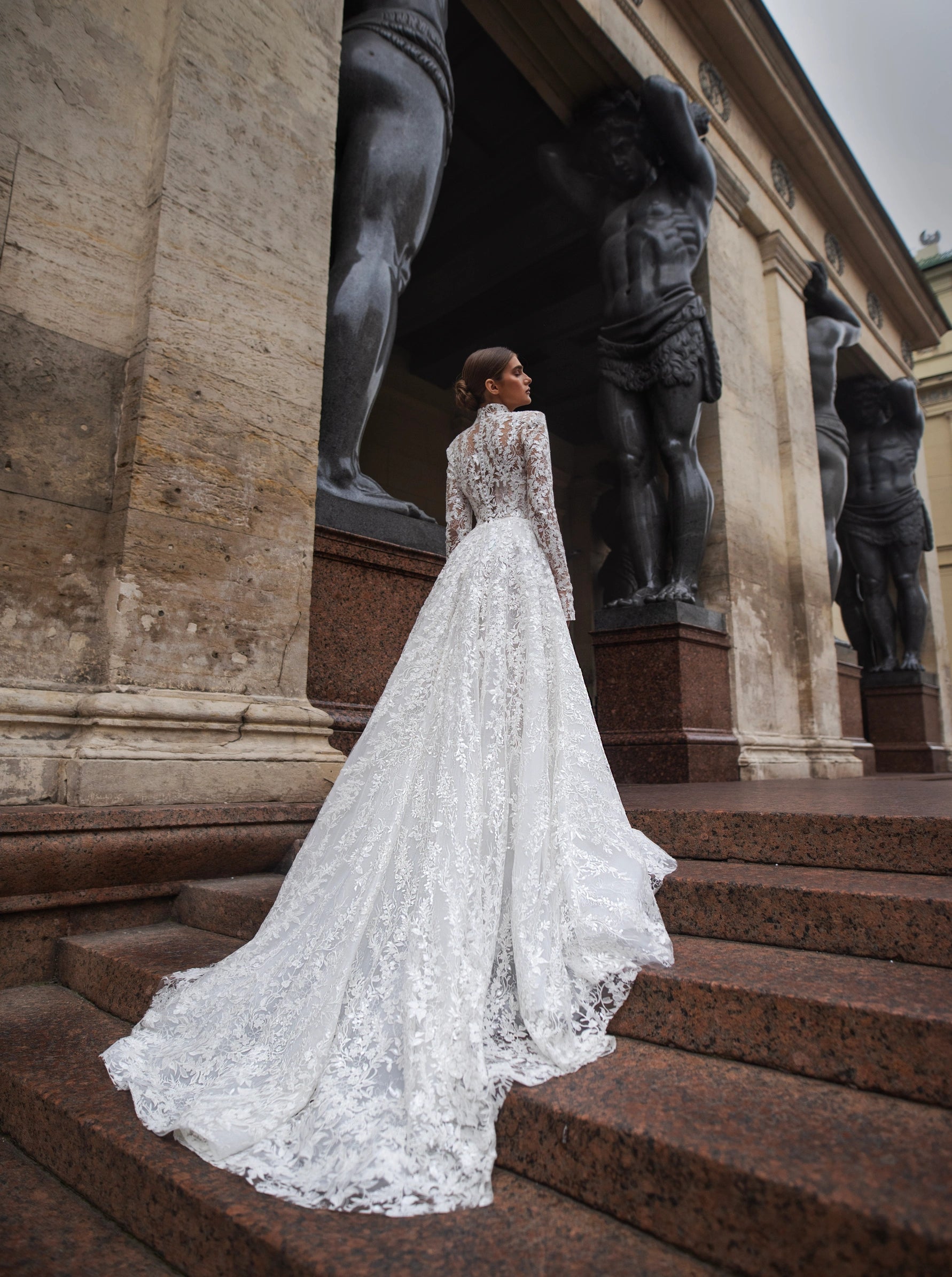 The Lidia Gown is the perfect wedding dress for the modern bride. With a flattering A-line silhouette, elegant long sleeves, and a high collar neckline, this gown is made from delicate lace and embellished with stunning sequins. Make a statement on your special day with this one-of-a-kind gown.