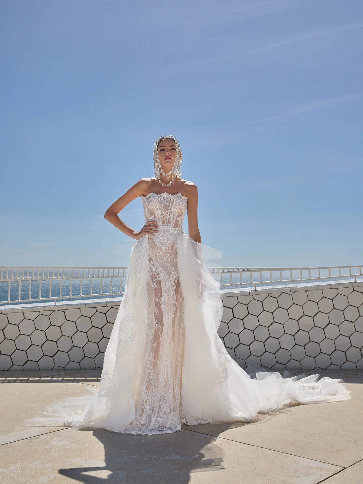 Indulge in pure luxury with the Eva Gown by Galia Lahav. This two-piece ensemble boasts a baroque-style strapless corset and an elongated mermaid skirt, both crafted from opulent embroidered French lace. The result is a striking and timeless silhouette that radiates elegance and grandeur. Elevate your style and make a statement with the Eva Gown.