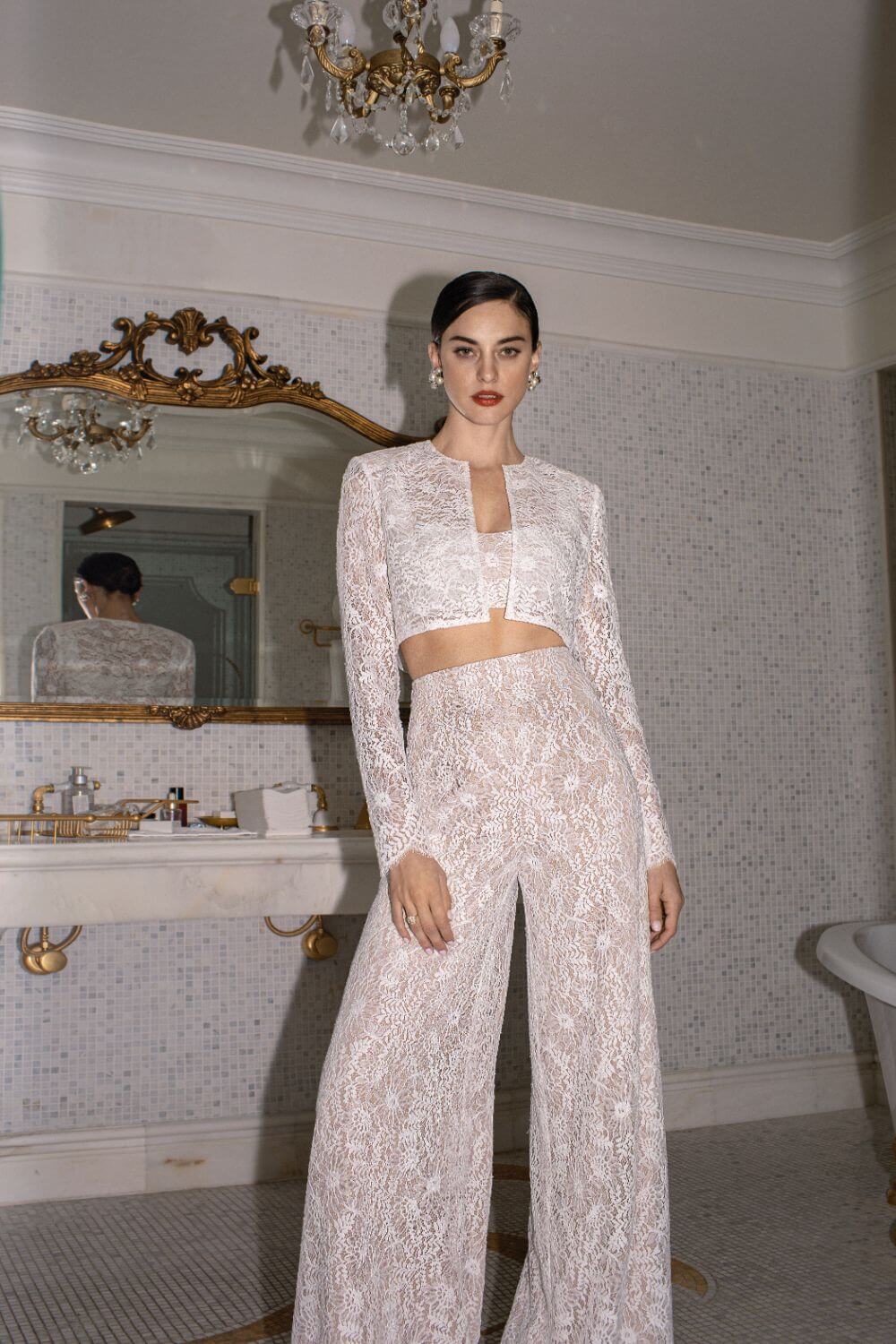 Step back in time with the Vivienne Set! This retro-inspired pant suit includes a lace crop top and little jacket, perfect for the bold and modern bride. Get the best of both worlds with a nod to the sixties and a chic, wild child twist. Say "I do" in style and turn heads with this stunning ensemble.