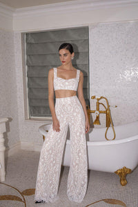 Step back in time with the Vivienne Set! This retro-inspired pant suit includes a lace crop top and little jacket, perfect for the bold and modern bride. Get the best of both worlds with a nod to the sixties and a chic, wild child twist. Say "I do" in style and turn heads with this stunning ensemble.