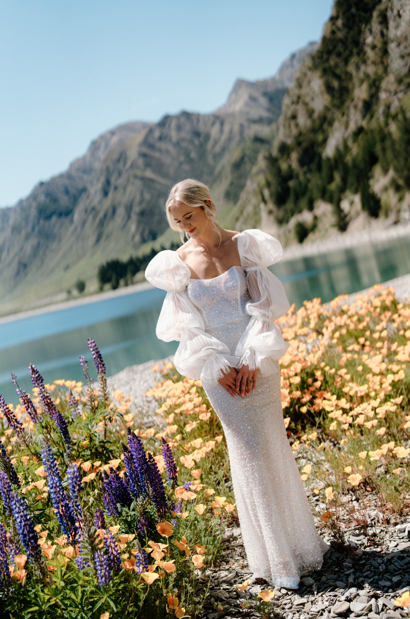 Take a risk on your wedding day with the Stella Dress! This stunning dress features a sequinned tulle column silhouette and a structured sweetheart bodice for a bold and statement-making look. Perfect for the daring bride who wants to stand out and make an unforgettable entrance.