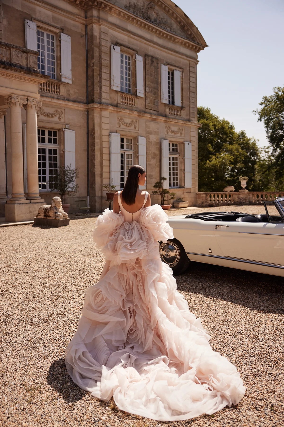 The Ellie Gown is the perfect choice for a sophisticated and modern bride. Made with elegant champagne pink elastic satin, this mermaid silhouette dress features a bustier corset with straps and a flattering geometric neckline. The skirt is fitted with intricate reliefs and a long train, creating a stunning and unique look for your special day.