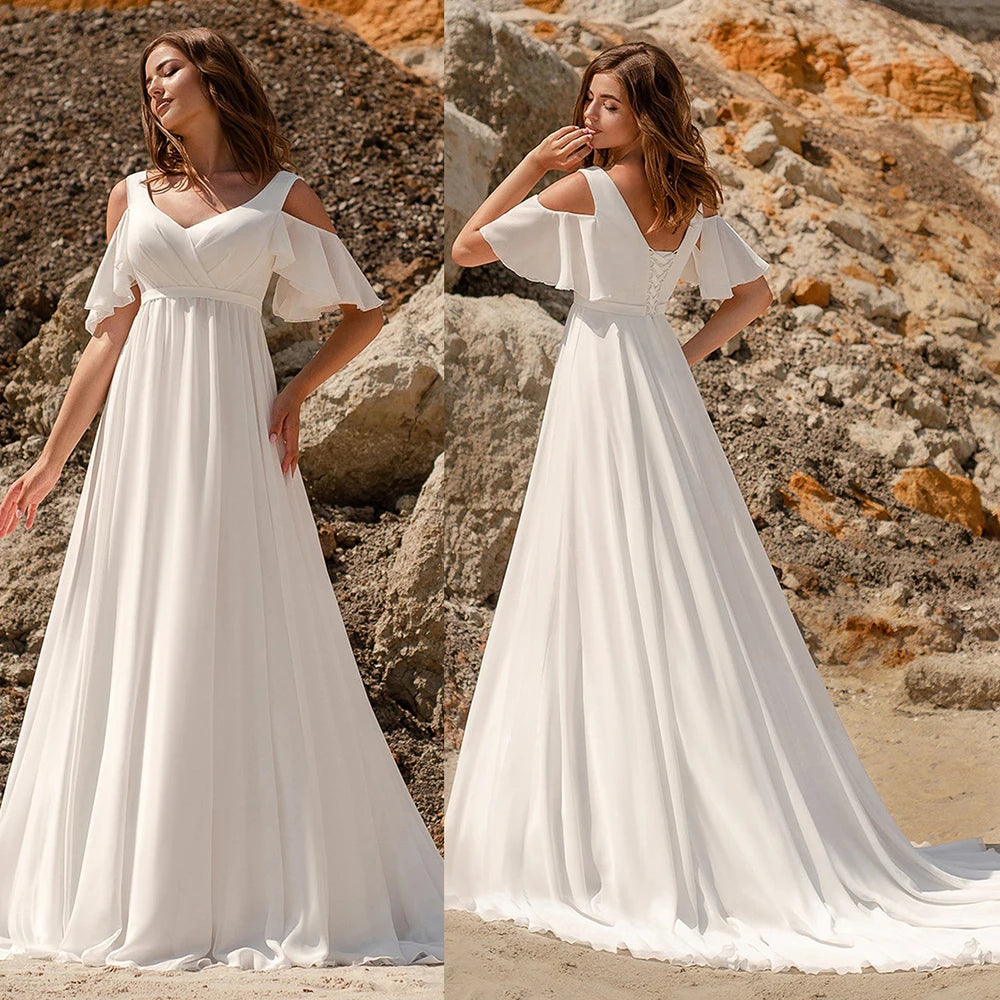 The Robe Minette is a stunning and elegant A-line wedding dress. The cape sleeves, made of delicate chiffon, add a touch of femininity and grace. The low back and sweep train create a simple yet alluring silhouette. Perfect for the modern and sophisticated bride.