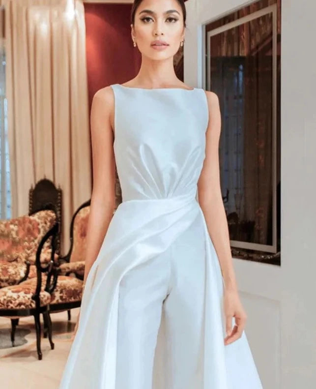 Unleash your fierce and playful side with Julissa, the ultimate luxury satin jumpsuit. Perfect for any occasion with its sleeveless design, O-Neck cut, and elegant sweep train. Zip yourself into style and stand out in this one-of-a-kind wedding dress. Get ready to turn heads and make a statement!