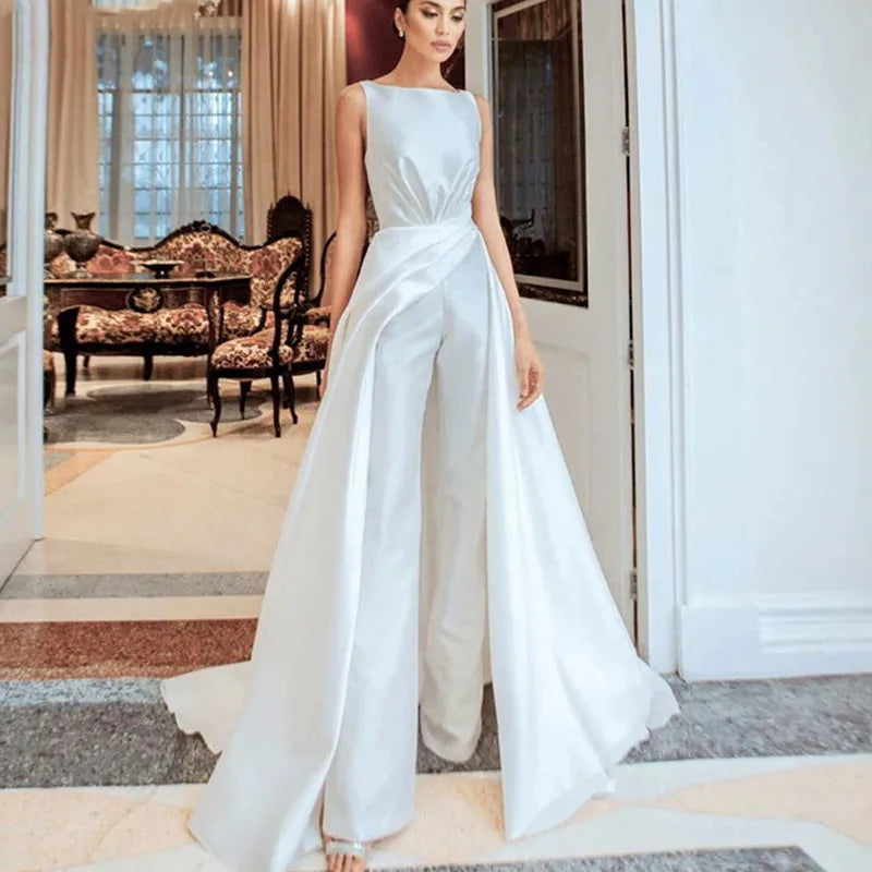 Unleash your fierce and playful side with Julissa, the ultimate luxury satin jumpsuit. Perfect for any occasion with its sleeveless design, O-Neck cut, and elegant sweep train. Zip yourself into style and stand out in this one-of-a-kind wedding dress. Get ready to turn heads and make a statement!