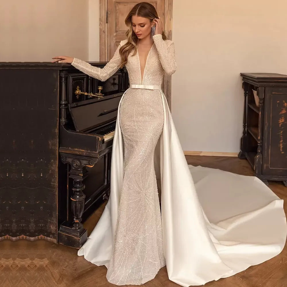 Discover the perfect dress for your special day with Dress Luna! Our stunning wedding gown features a V neckline and two-piece design, creating a sleek and elegant silhouette. The full long sleeves add a touch of sophistication to this luxurious dress. Be a showstopper on your wedding day with Dress Luna.