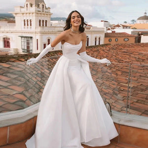 Transform into a regal vision with our Robe Bellisima. The elegant off shoulder design and detachable sleeves create a princess-like silhouette, perfect for a ball gown wedding. Crafted with luxurious detail and customizable for a flawless fit. Be a true queen on your special day.