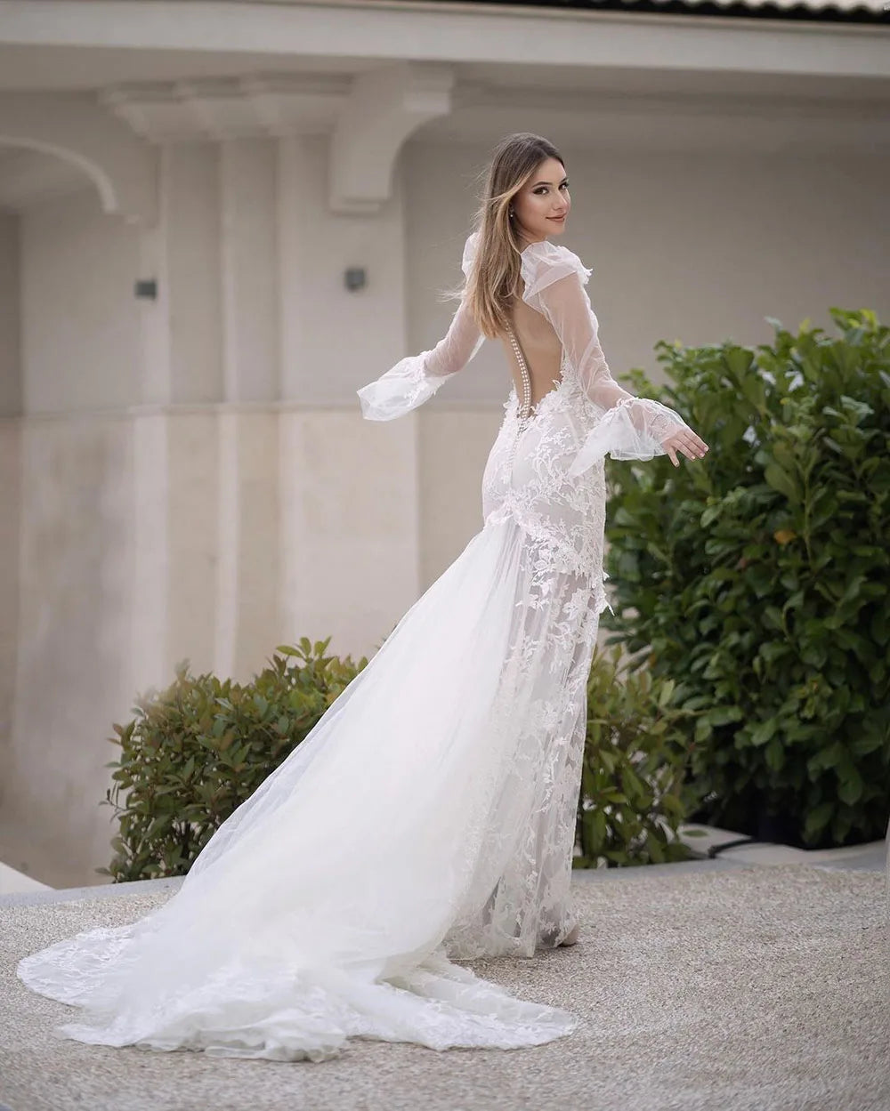 Elevate your bridal style with the Robe Pascale. This boho mermaid wedding dress features a V-neckline and puff long sleeves for a unique and elegant look. Made with high-quality materials, it offers both comfort and style on your special day. Embrace your inner mermaid and make a statement with this stunning bridal gown.