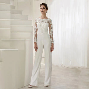 Elegance and versatility combine in our Combinaison Madisson. From the modest long sheer sleeves to the stunning lace detailing, this custom-made jumpsuit is perfect for the modern bride. The detachable skirt train adds a touch of drama, allowing you to seamlessly transition from ceremony to reception.