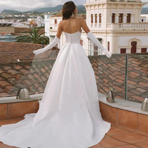 Transform into a regal vision with our Robe Bellisima. The elegant off shoulder design and detachable sleeves create a princess-like silhouette, perfect for a ball gown wedding. Crafted with luxurious detail and customizable for a flawless fit. Be a true queen on your special day.