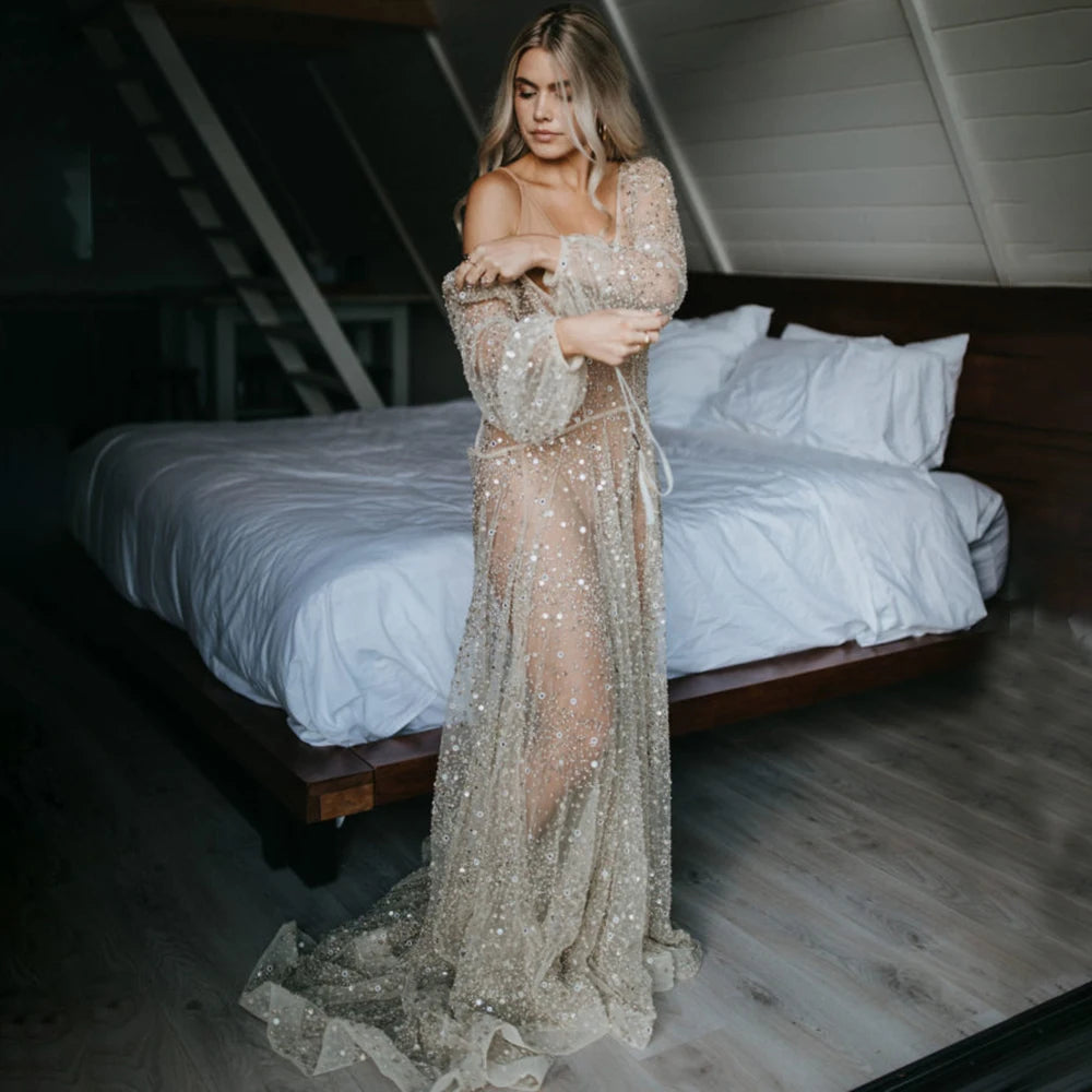 Indulge in the opulence of our Dress Carrie. This luxurious A-line gown boasts intricate beading, a see-through V-neckline, and a backless design. Adorned with sparkling Swarovski crystals and flowing layers of illusion tulle, it's a custom-made masterpiece fit for a bride's most special day.