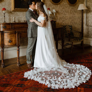 Indulge in the romance of a fairytale wedding with the Bloom Flowers Romantic Wedding Dress Michelle. This custom-made off-white mesh veil comes with a delicate blusher that adds elegance to your bridal look. The comb headpiece adds a touch of glamour and compliments your beauty on your special day.