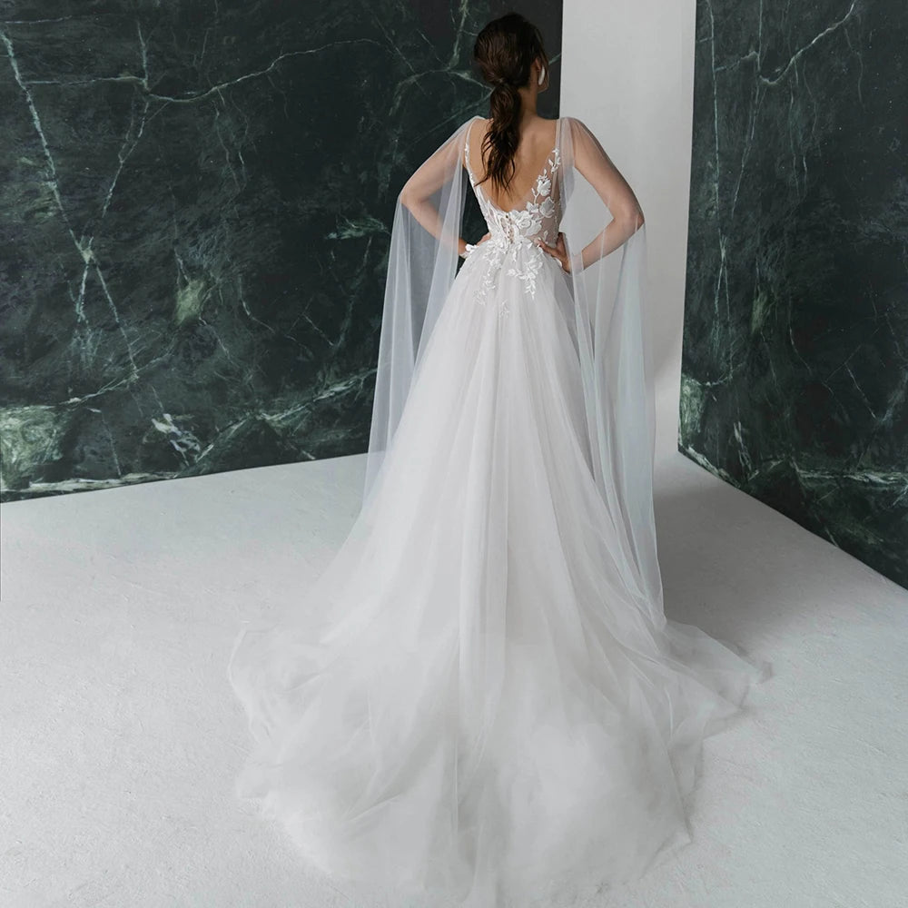 Get ready to turn heads in our Robe Nanou wedding dress. Boasting a V neck, exquisite embroidery, lace, and tulle, this A Line gown is custom-made to perfection. Leave a lasting impression with its open back, elegant pearls, and see-through detailing. The high split shoulder train adds a touch of glamour, making it the perfect choice for your special day.