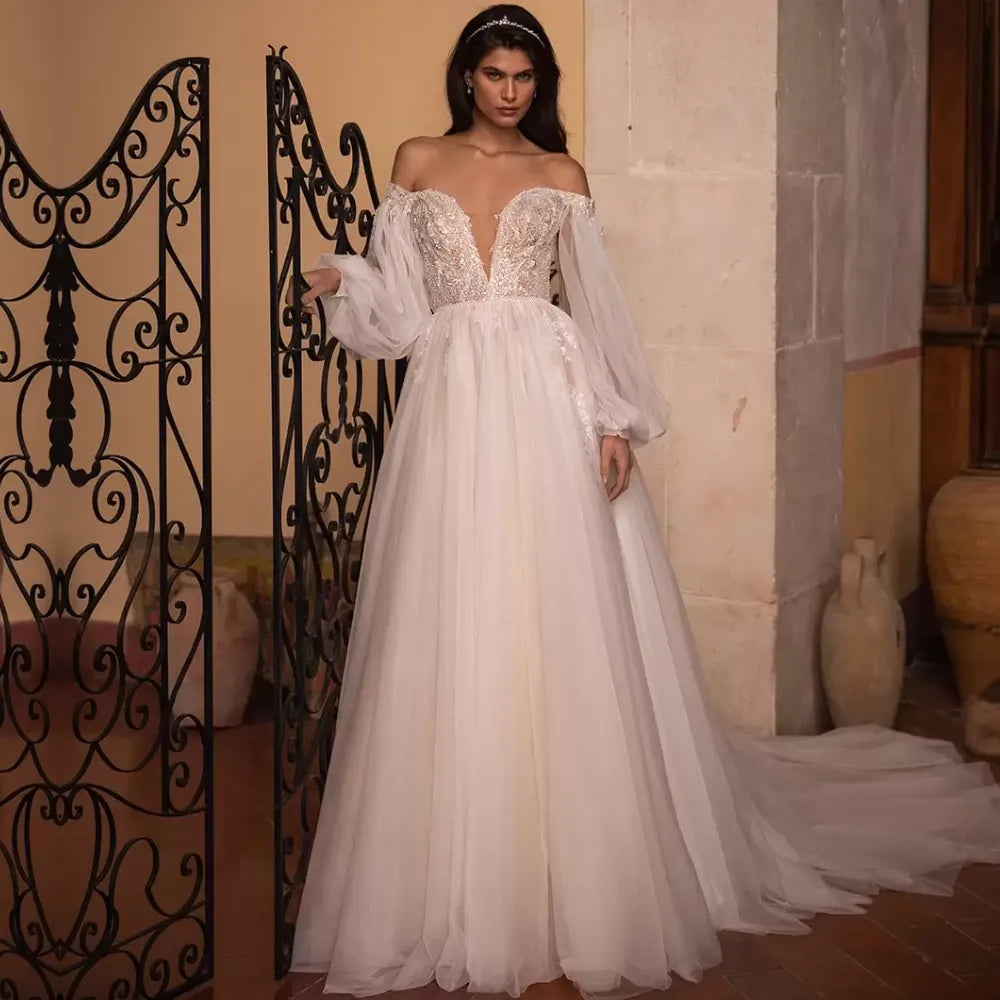 Introducing the Robe Marlene - the perfect bridal gown for those who want to make a statement! With its long full puff sleeves and A-line silhouette, this gown will make any bride feel like a fairy tale princess.