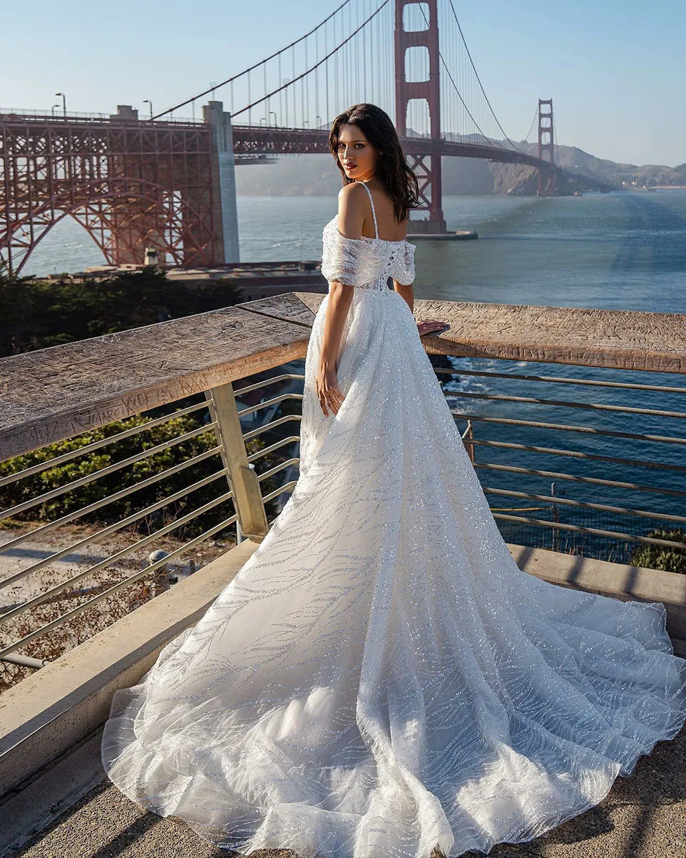 The Robe Tracy is a stunning Glitter Mermaid Wedding Dress with a detachable train and an off shoulder design. With its sparkly details, it will make any bride feel like a mermaid princess on her special day. Its unique features provide both style and convenience, making it a must-have for any bride-to-be.