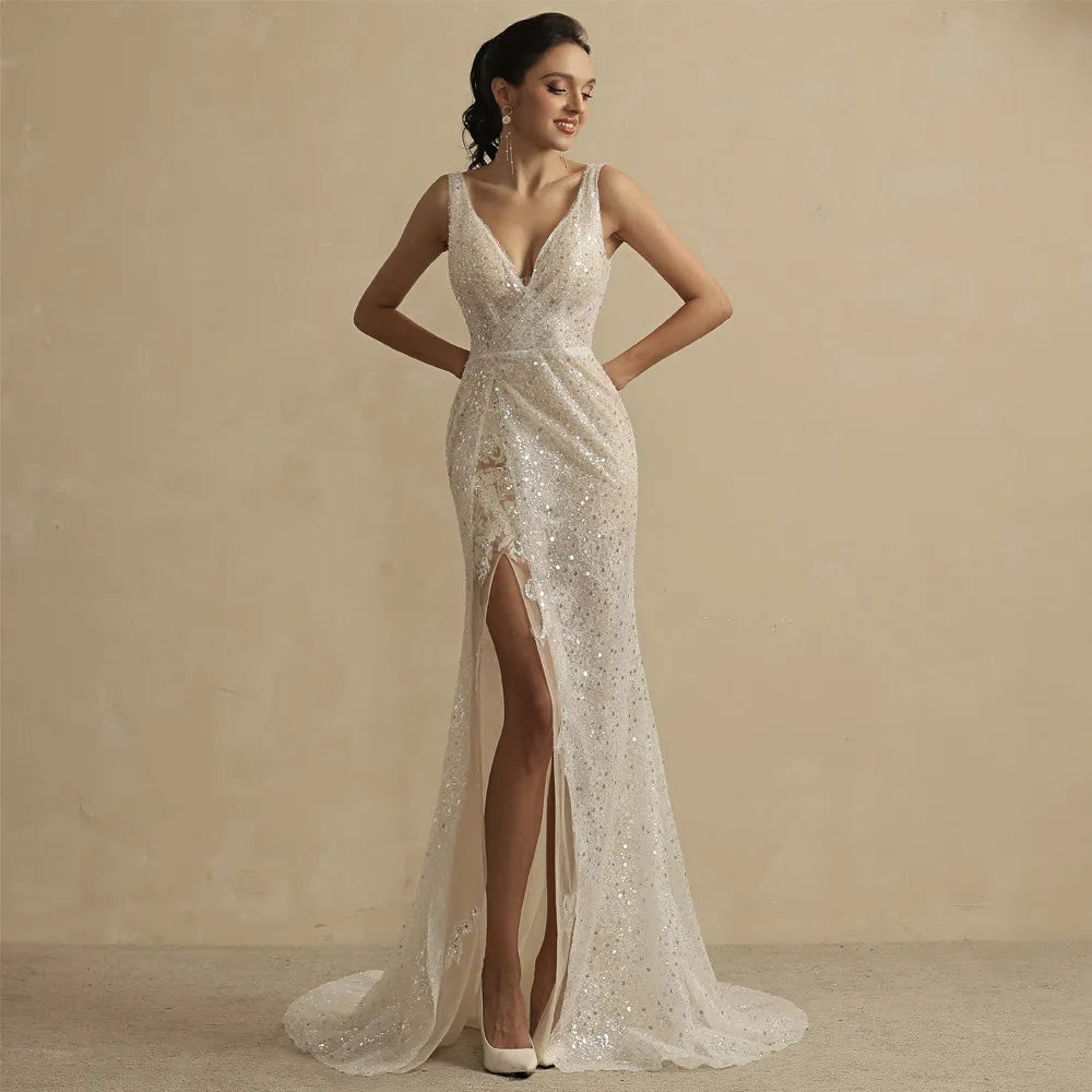 Look like a goddess on your special day in this stunning Robe Lou gown! Itsluxurious lace is embellished with glitter, and it has a romantic high slit and low back. This elegant bridal gown is sure to make you the star of any wedding!