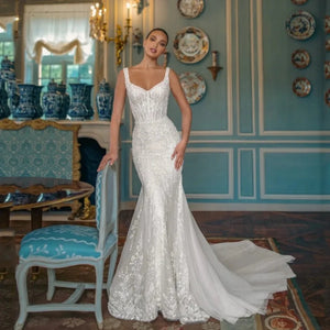 Indulge in sophistication and elegance with our exquisite Robe Fabienne. This square-neck A-line wedding dress features intricate lace appliques and sparkling sequins, exuding the charm and grace of a true bride. Crafted with luxurious tulle, the sweep train adds a touch of romance to this stunning gown.