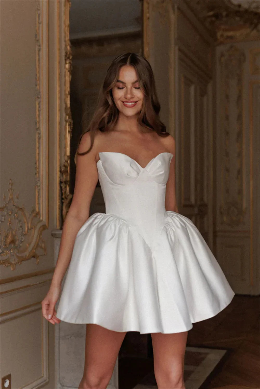 Fall in love with the elegant Ella mini dress, perfect for any bride-to-be. Made with luxurious white satin fabric and designed with a strapless, sleeveless heart-shaped neckline, this dress exudes sophistication and charm. Its short length adds a modern touch, making it the ideal dress for any wedding occasion.