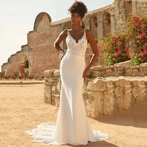 Expertly crafted with delicate lace appliques, the Dress Marietta is a stunning wedding dress with spaghetti straps and a flattering mermaid silhouette. Perfect for a beach wedding, the backless design adds a touch of allure to this elegant gown. Embrace your inner bride in the Dress Marietta.