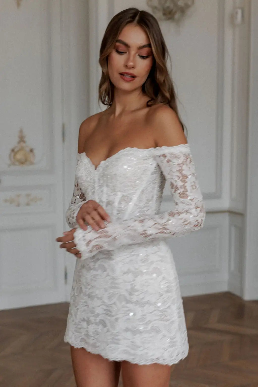 Expertly crafted with lace appliques and an elegant off shoulder design, the Robe Noemie is the perfect choice for any special occasion. The heart shaped neck adds a touch of romance to this elegant white mini dress. Make a statement and feel confident and beautiful all night long.