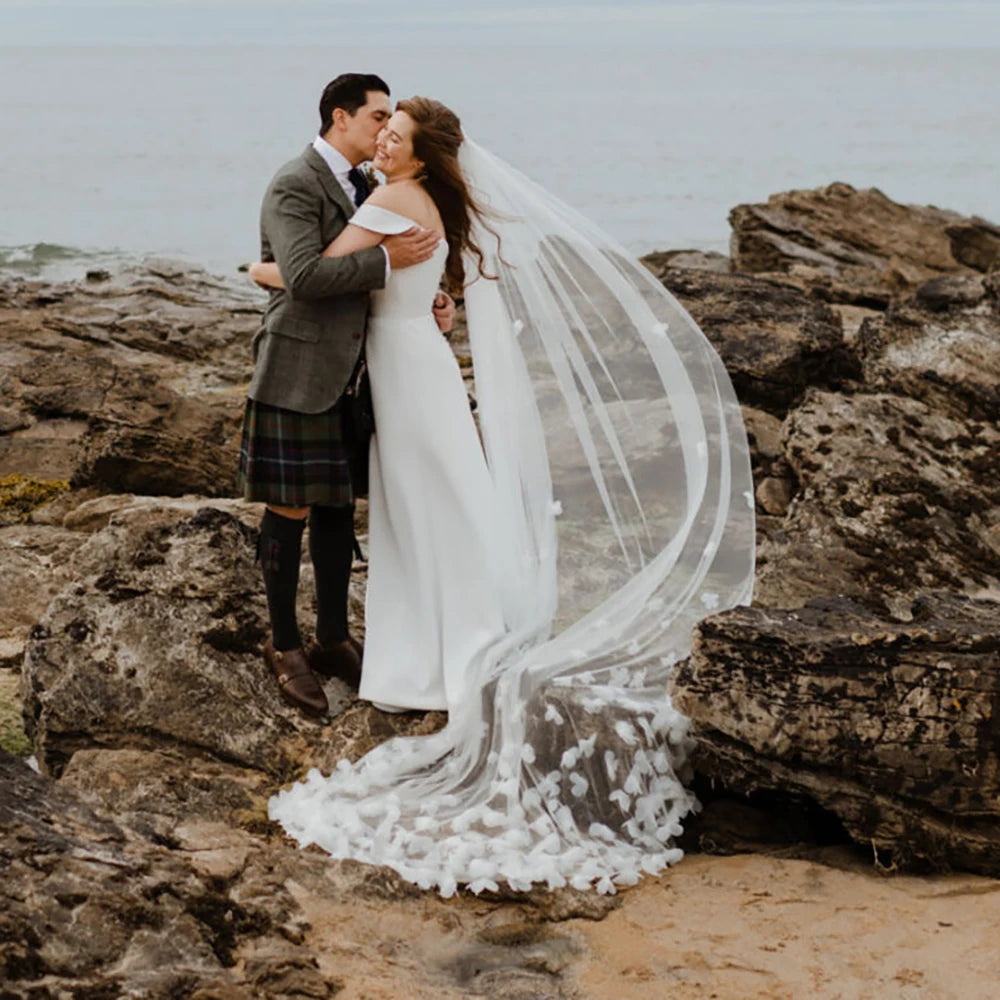 Indulge in the romance of a fairytale wedding with the Bloom Flowers Romantic Wedding Dress Michelle. This custom-made off-white mesh veil comes with a delicate blusher that adds elegance to your bridal look. The comb headpiece adds a touch of glamour and compliments your beauty on your special day.