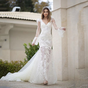 Elevate your bridal style with the Robe Pascale. This boho mermaid wedding dress features a V-neckline and puff long sleeves for a unique and elegant look. Made with high-quality materials, it offers both comfort and style on your special day. Embrace your inner mermaid and make a statement with this stunning bridal gown.