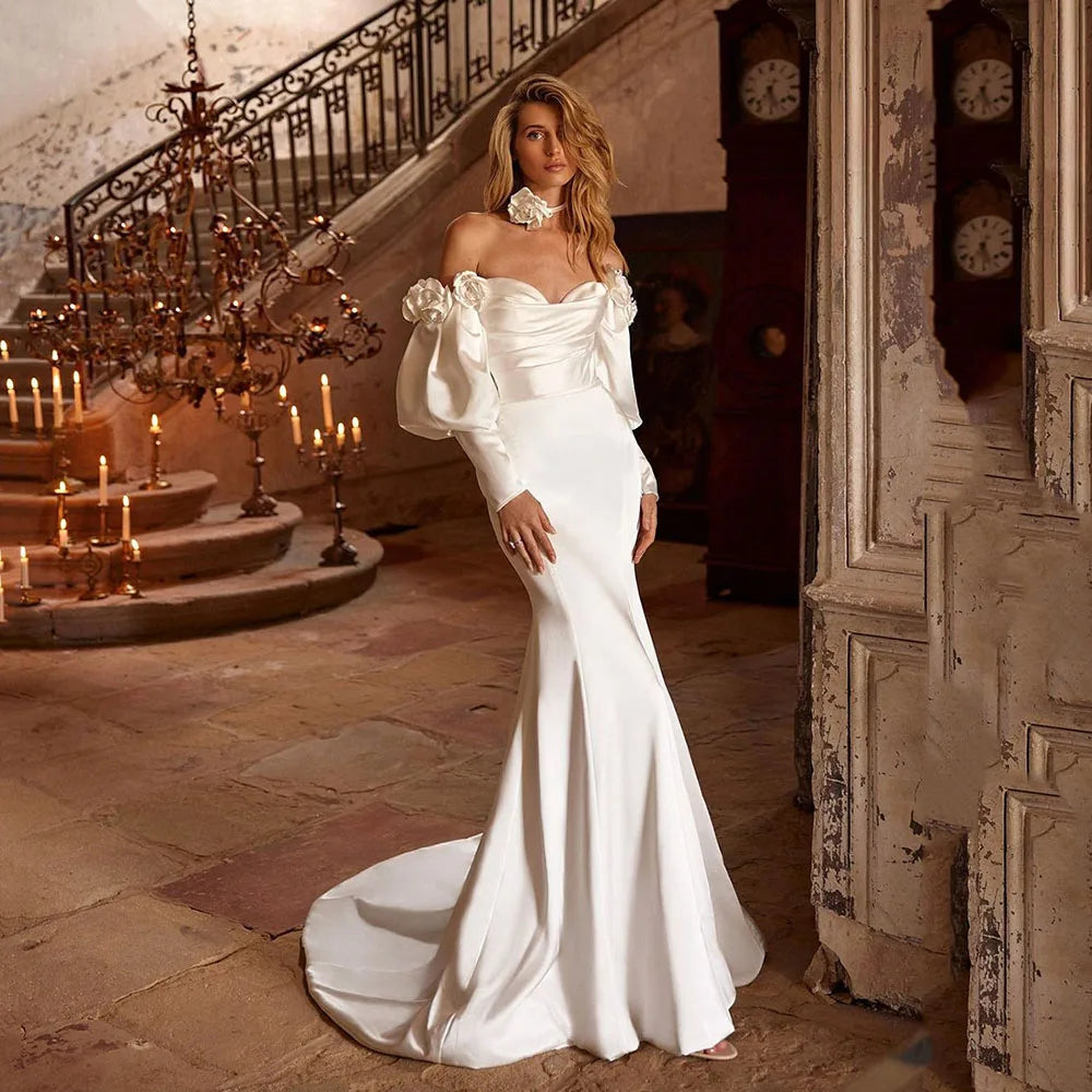 Indulge in the luxurious elegance of our Robe Gabby. This unique Boho Mermaid Wedding Dress features an off-the-shoulder design and a stunning satin fabric, making you the center of attention at any event. Embrace your inner mermaid and stand out in style with this timeless piece.