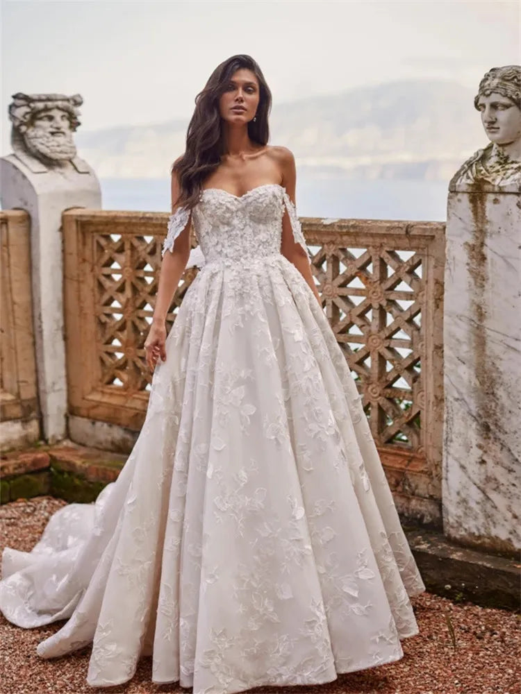 Indulge in the exquisite elegance of our Robe Domitille. This lace wedding dress boasts a stunning ball gown silhouette, designed to make any woman feel like royalty on her special day. With delicate lace detailing, this dress exudes luxury and sophistication, perfect for the most memorable moments.