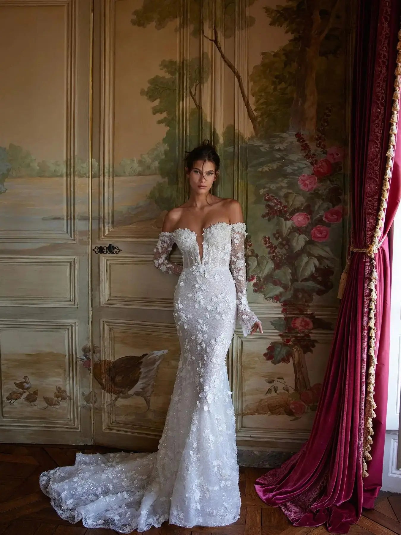 Elevate your bridal elegance with Robe Beline. This luxurious dress features a stunning lace design and a figure-hugging mermaid silhouette that will make you feel like a true queen on your special day. The long-sleeved, off-shoulder design adds a touch of romance and sophistication to this must-have wedding dress.