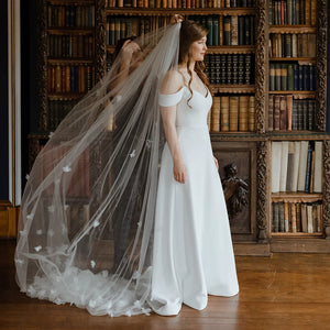 Indulge in the romance of a fairytale wedding with the Bloom Flowers Romantic Wedding Dress Michelle. This custom-made off-white mesh veil comes with a delicate blusher that adds elegance to your bridal look. The comb headpiece adds a touch of glamour and compliments your beauty on your special day.