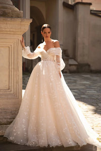 This exquisite Robe Henriette is perfect for the modern princess bride. The elegant long sleeves and voluminous ball gown silhouette create a regal look that will make you feel like royalty on your special day. Made for the romantic at heart, this dress is sure to make you feel like a true princess.