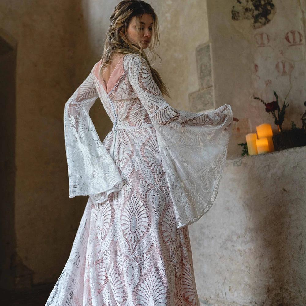 Indulge in luxury with our Robe Solstice, handmade at our exclusive factory. The scoop neck and loose batwing sleeves create a flattering silhouette, while the delicate lace adds an elegant touch. Perfect for a boho-inspired wedding, this dress will make you feel like the most beautiful and unique bride. Custom-made just for you.