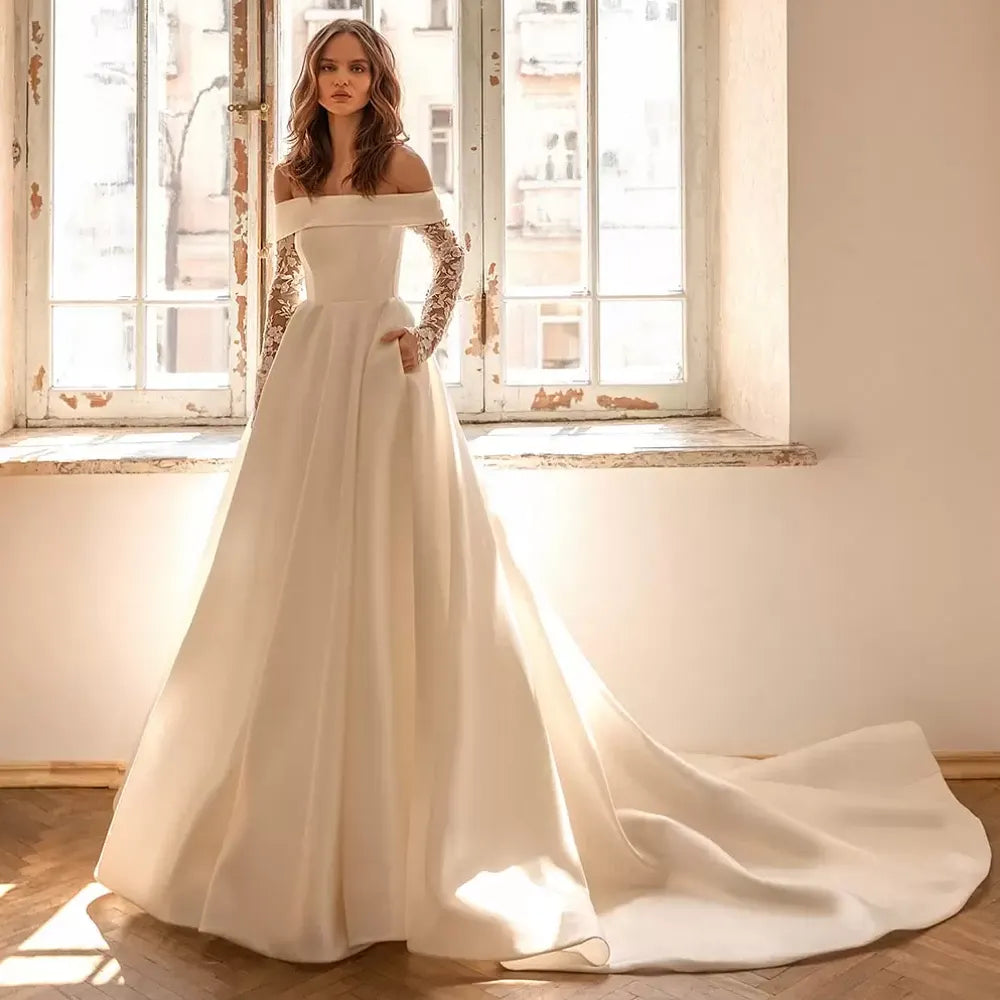 This stunning mermaid style wedding dress features a delicate boat neckline, long sleeves, and an A-line silhouette crafted from luxurious satin fabric. Perfect for modern brides, Robe Mireille is designed to flatter the female figure and capture the timeless elegance of a classic wedding dress.