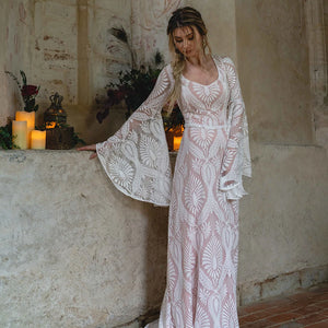 Indulge in luxury with our Robe Solstice, handmade at our exclusive factory. The scoop neck and loose batwing sleeves create a flattering silhouette, while the delicate lace adds an elegant touch. Perfect for a boho-inspired wedding, this dress will make you feel like the most beautiful and unique bride. Custom-made just for you.