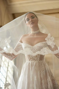 Indulge in luxury and grace with our Robe Colette. This lace wedding dress boasts simple elegance with a long-sleeved, graceful design. Perfect for the sophisticated bride, this vestido de novia will add a touch of timeless charm to your special day. Prepare to turn heads and capture hearts with this exclusive piece.